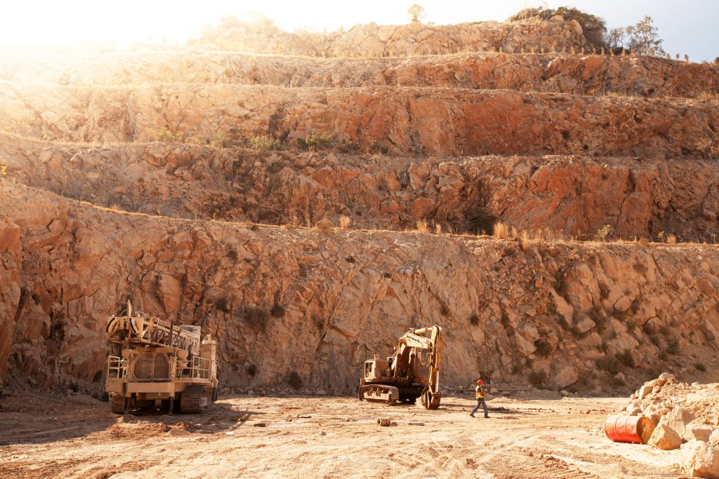A man is walking in a mining pit.