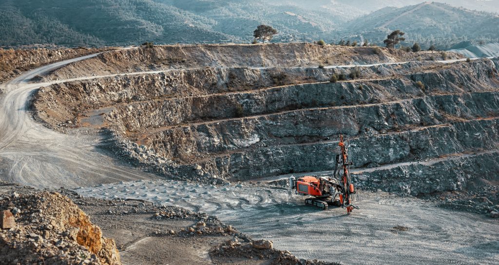 A dredger is parked inside a mine.